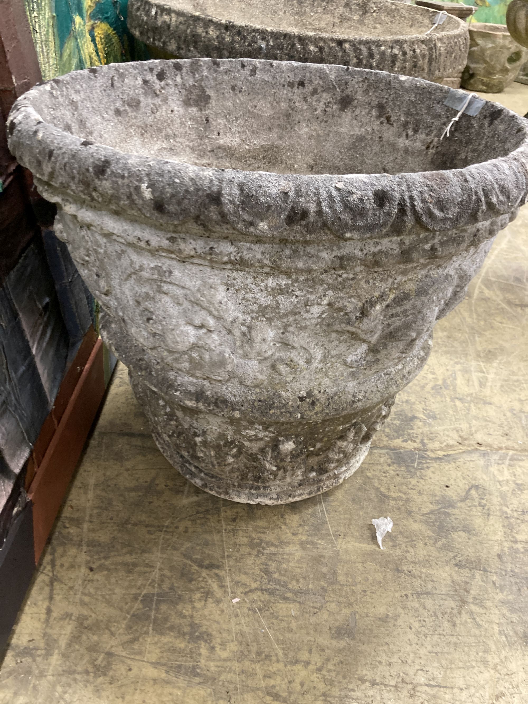 A pair of reconstituted stone circular garden urns, diameter 55cm, height 48cm